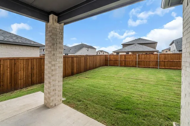 a view of a house with wooden fence