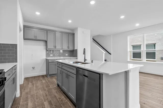 a kitchen with a sink stove and cabinets