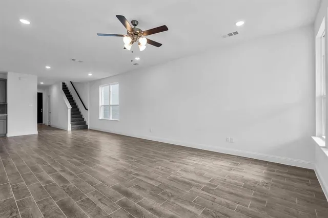 a view of an empty room with a kitchen