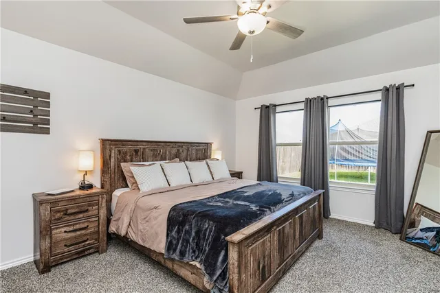 a bed sitting in a room next to a window