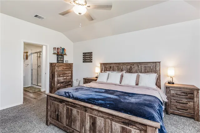 a large bedroom with a bed and a chandelier