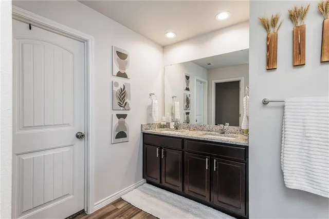 a bathroom with a sink a mirror and a shower