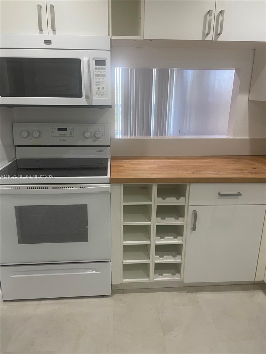 10525 Southwest 112th Avenue, Unit 315 Miami, FL 33176 - Photo 2 of 9 a stove top oven sitting inside of a kitchen
