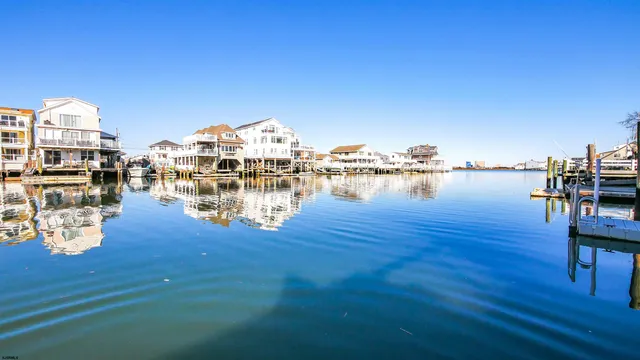 a view of a lake with boats and trees in the background