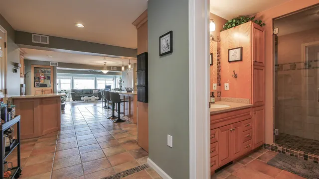 a bathroom with a granite countertop sink and a mirror