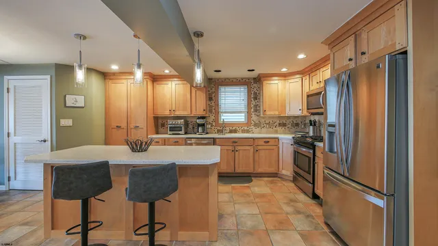 a large kitchen with lots of counter space and stainless steel appliances
