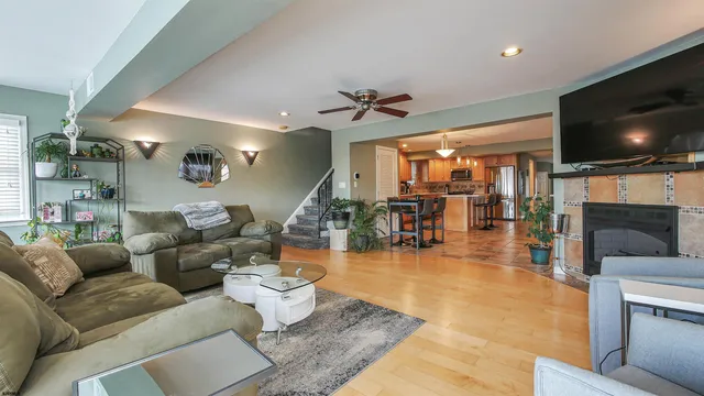 a living room with furniture a fireplace and a chandelier