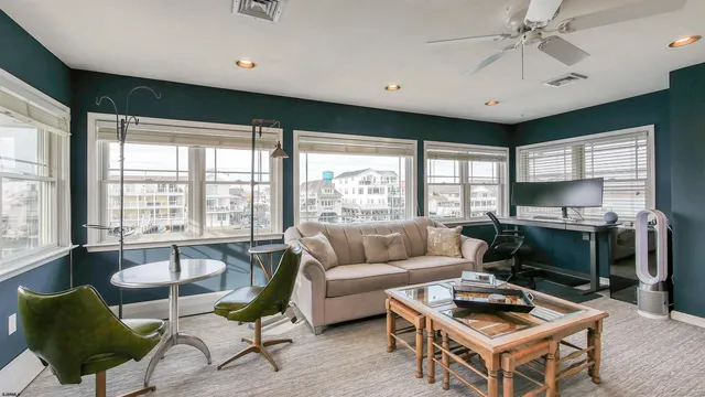 a living room with furniture a window and flat screen tv
