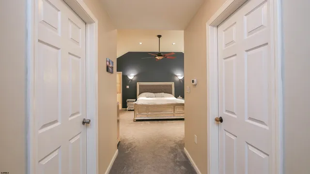 a bedroom with a bed and a ceiling fan