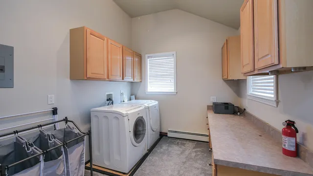 a bedroom with a bed a mirror on dresser and a chandelier
