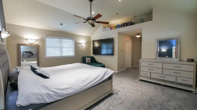 a bathroom with a granite countertop sink a mirror and shower