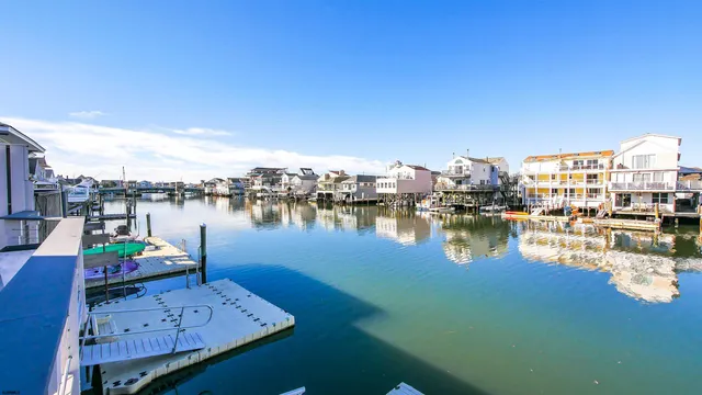 a view of a lake with chairs