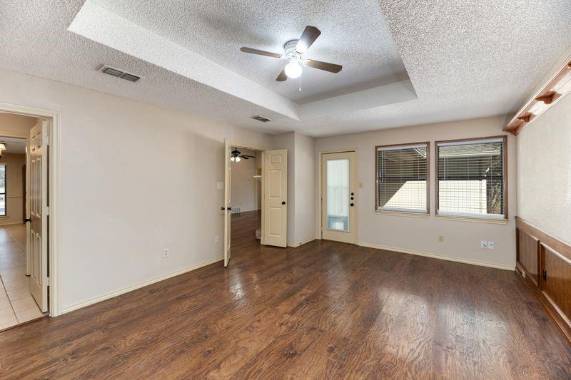 922 Kingston Drive Mansfield, TX 76063 - Photo 11 of 24 a view of empty room with wooden floor and fan