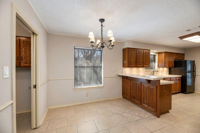 922 Kingston Drive Mansfield, TX 76063 - Photo 13 of 24 a kitchen with stainless steel appliances granite countertop a refrigerator and a sink