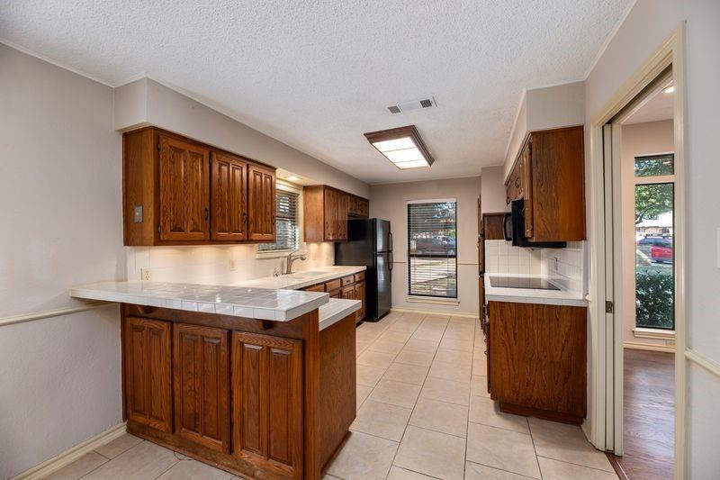 922 Kingston Drive Mansfield, TX 76063 - Photo 14 of 24 a kitchen with stainless steel appliances granite countertop a refrigerator and a stove