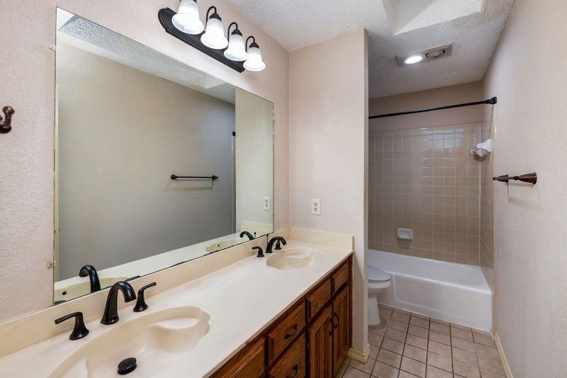 922 Kingston Drive Mansfield, TX 76063 - Photo 22 of 24 a bathroom with a sink a toilet and shower