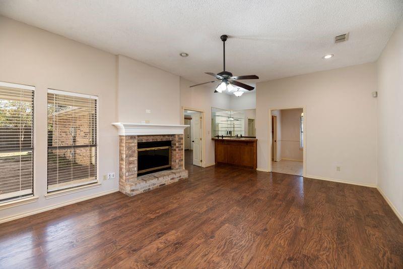 922 Kingston Drive Mansfield, TX 76063 - Photo 7 of 24 a view of a livingroom with a fireplace wooden floor and chandelier