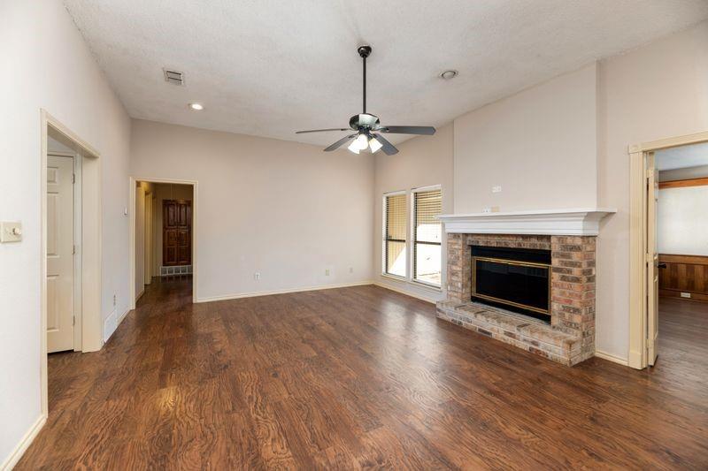 922 Kingston Drive Mansfield, TX 76063 - Photo 8 of 24 a view of an empty room with wooden floor fireplace and a window