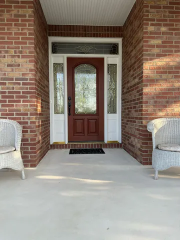 a view of front door of house with stairs