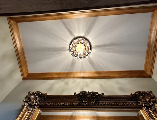 a living room with a couch and chandelier