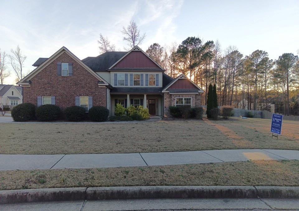 a front view of a house with a yard