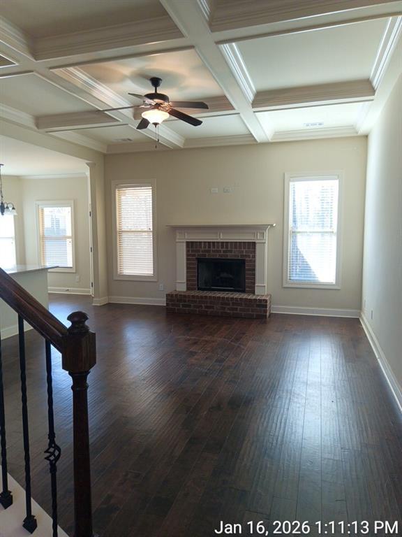 307 Cinnamon Bark Pass Locust Grove, GA 30248 - Photo 17 of 26 an empty room with wooden floor fireplace and windows