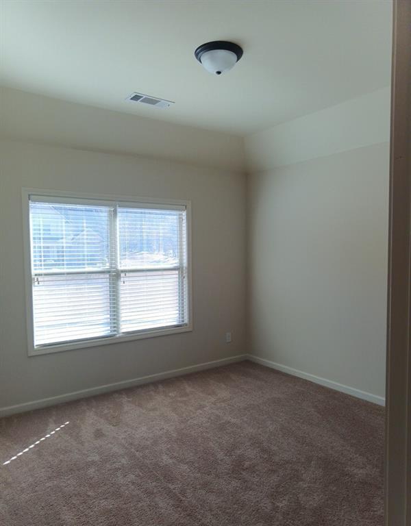 307 Cinnamon Bark Pass Locust Grove, GA 30248 - Photo 19 of 26 an empty room with a window