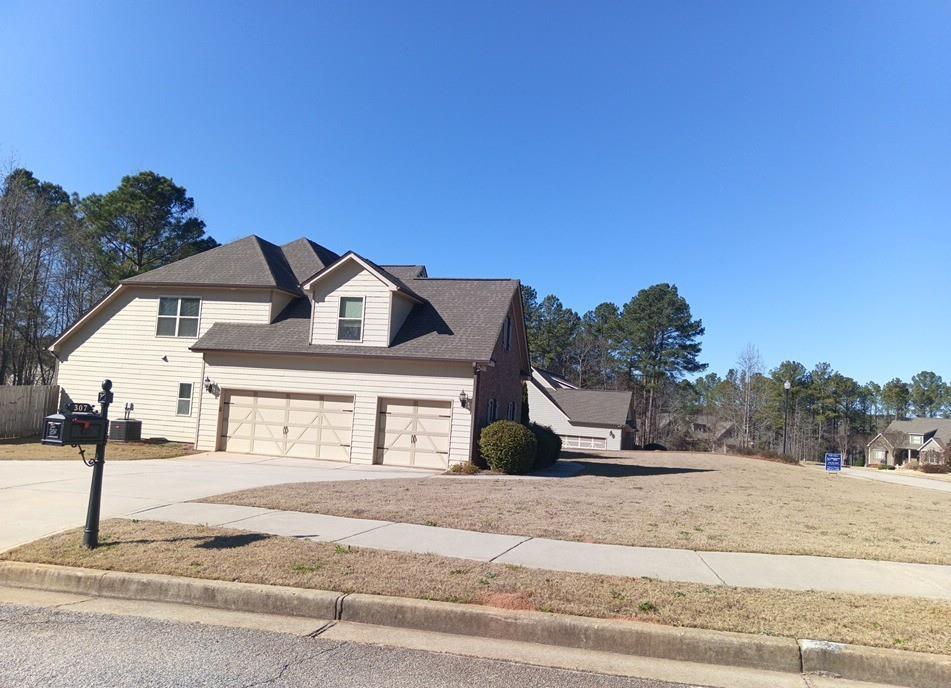 307 Cinnamon Bark Pass Locust Grove, GA 30248 - Photo 24 of 26 a front view of a house with a yard