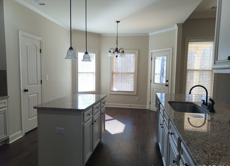 307 Cinnamon Bark Pass Locust Grove, GA 30248 - Photo 8 of 26 a kitchen with granite countertop a stove a sink and a window