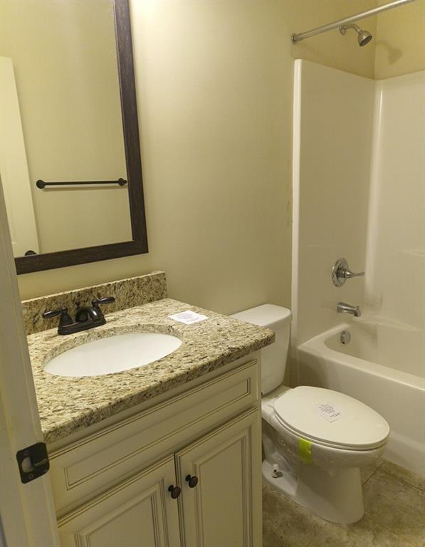 307 Cinnamon Bark Pass Locust Grove, GA 30248 - Photo 9 of 26 a bathroom with a granite countertop sink toilet and shower