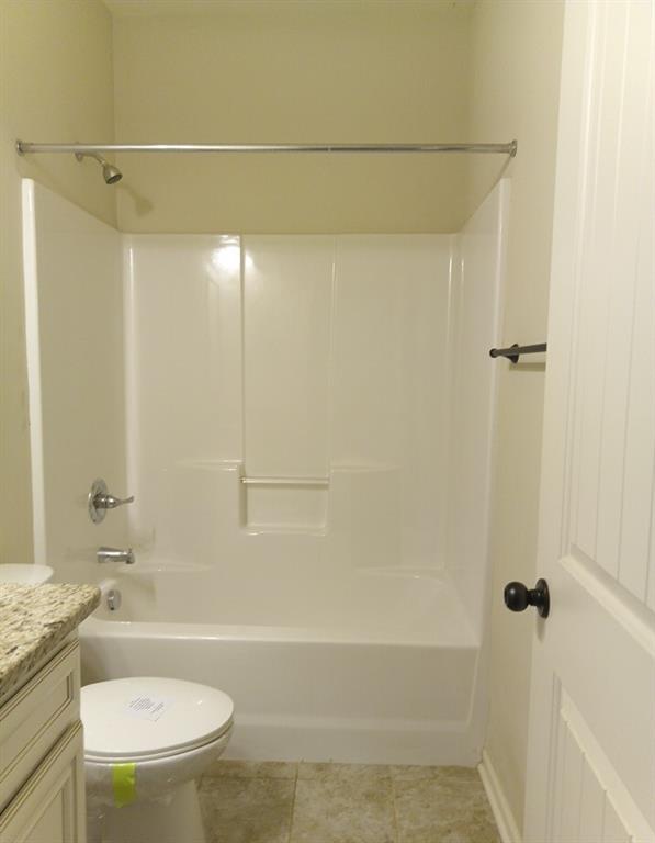 307 Cinnamon Bark Pass Locust Grove, GA 30248 - Photo 10 of 26 a bathroom with a granite countertop bathtub shower sink vanity and toilet