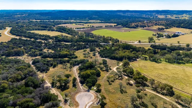 a view of a lush green hillside and houses