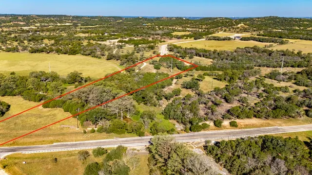 a view of dirt field with trees