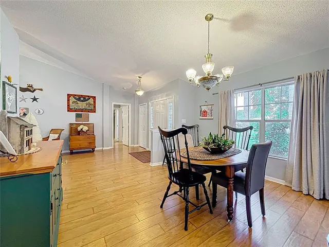 a kitchen with a sink cabinets and living room view