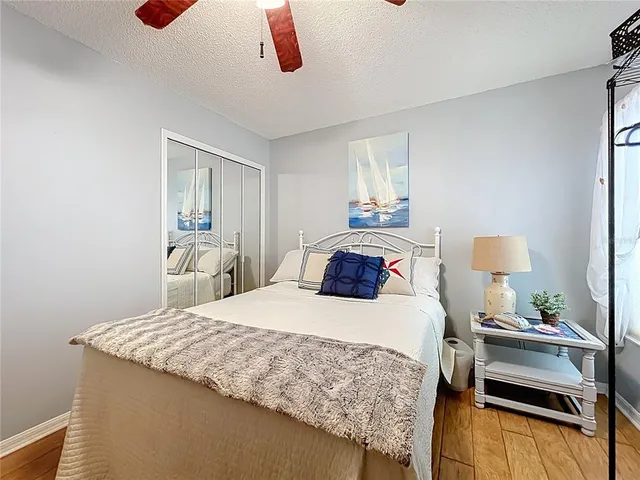 a spacious bedroom with a bed and a table in it