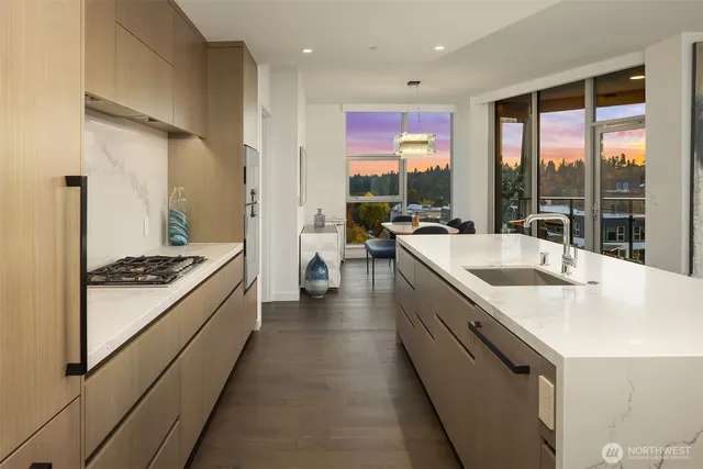 a dining room with furniture a chandelier and wooden floor