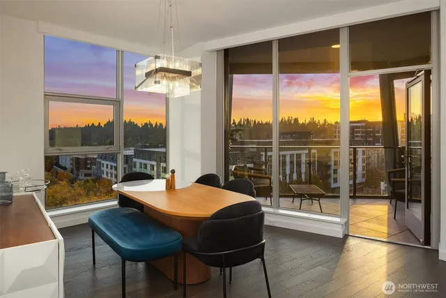 a view of a balcony with chairs and a potted plant