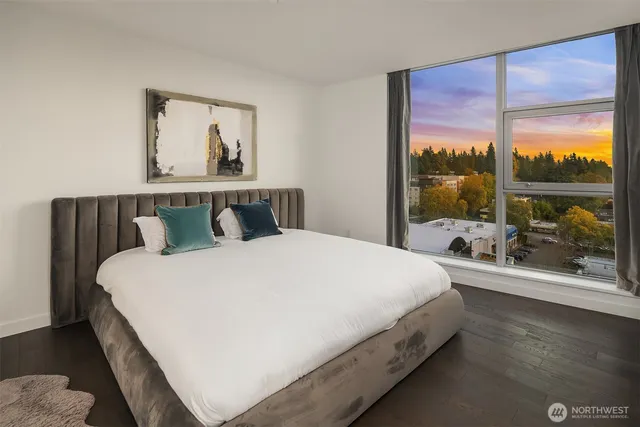 a bedroom with a bed and painting on the wall