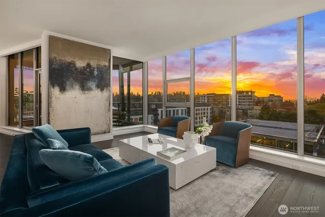 a living room with furniture and a floor to ceiling window