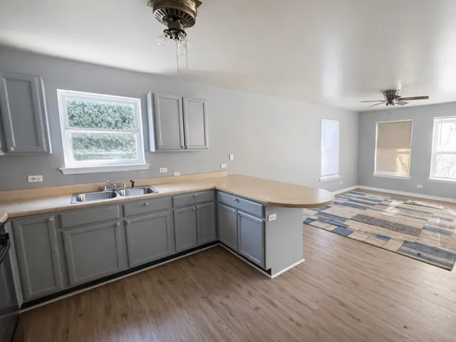 a kitchen with granite countertop white cabinets and a dishwasher