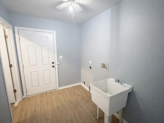 a view of a room with wooden floor