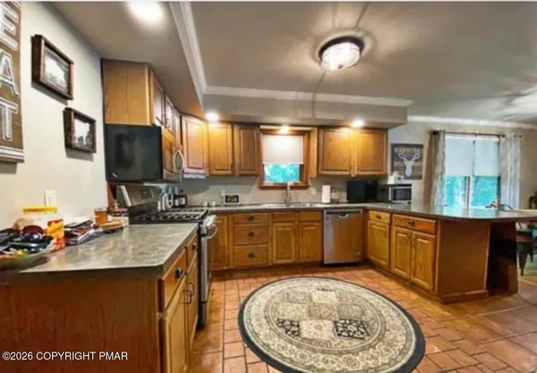 a large kitchen with a sink and cabinets