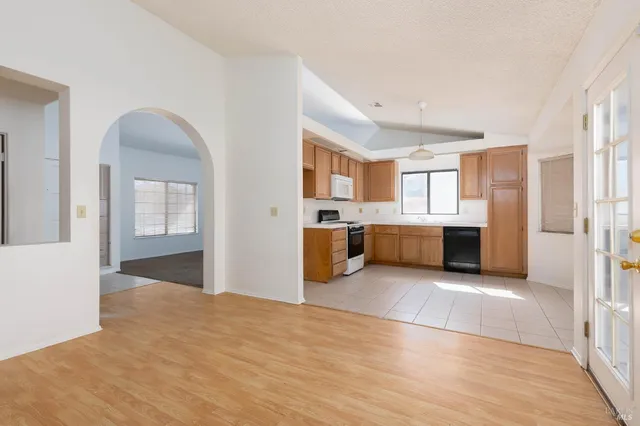 a large kitchen with a refrigerator and a sink