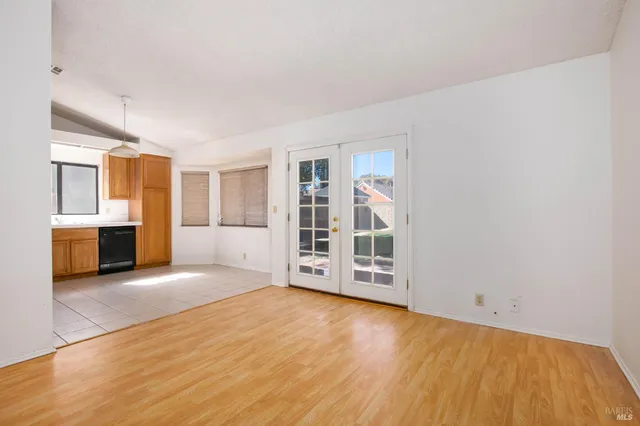 a view of an empty room with a window and fire place