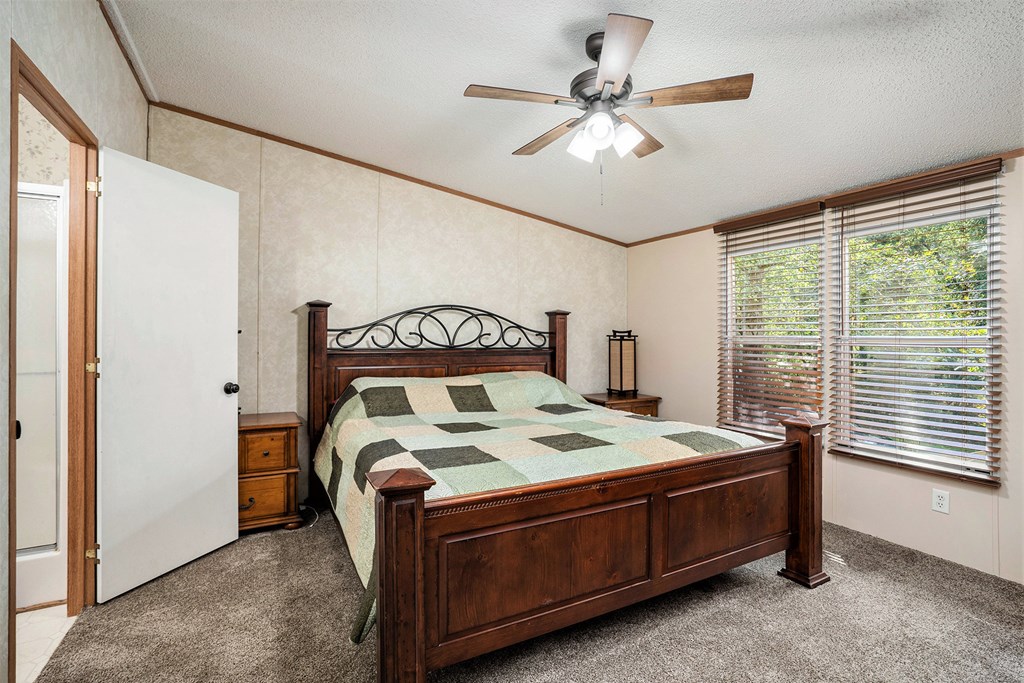 359 Norton Bridge Road Chatsworth, GA 30705 - Photo 12 of 28 a bed sitting in a room next to a window