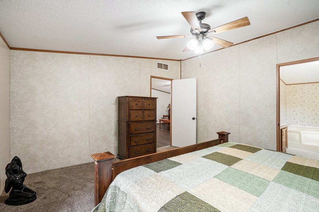 359 Norton Bridge Road Chatsworth, GA 30705 - Photo 14 of 28 a bedroom with a bed and a chandelier
