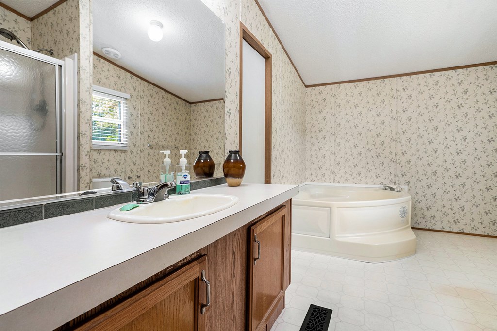 359 Norton Bridge Road Chatsworth, GA 30705 - Photo 15 of 28 a bathroom with a granite countertop sink a toilet a mirror and shower