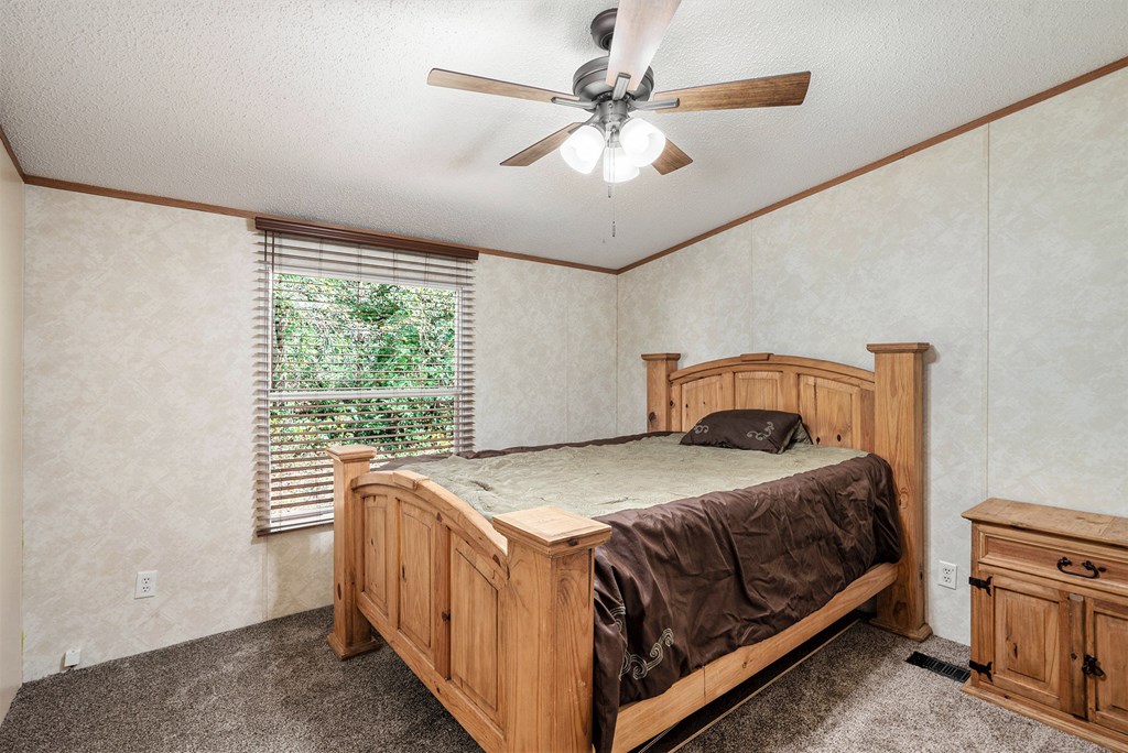 359 Norton Bridge Road Chatsworth, GA 30705 - Photo 20 of 28 a bedroom with a bed and a ceiling fan