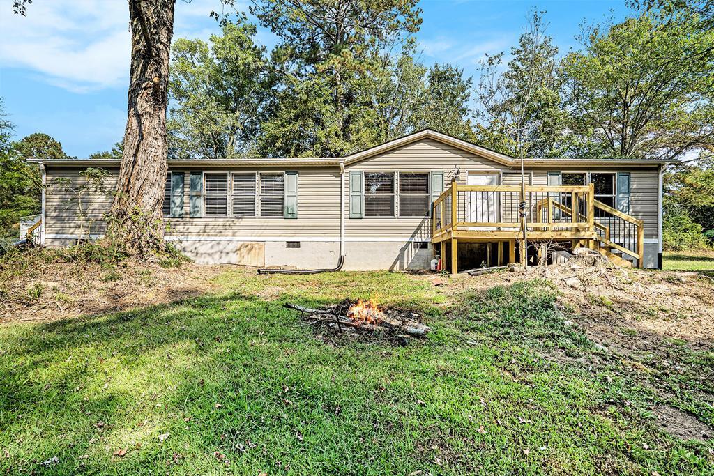 359 Norton Bridge Road Chatsworth, GA 30705 - Photo 2 of 28 a front view of a house with a yard table and chairs