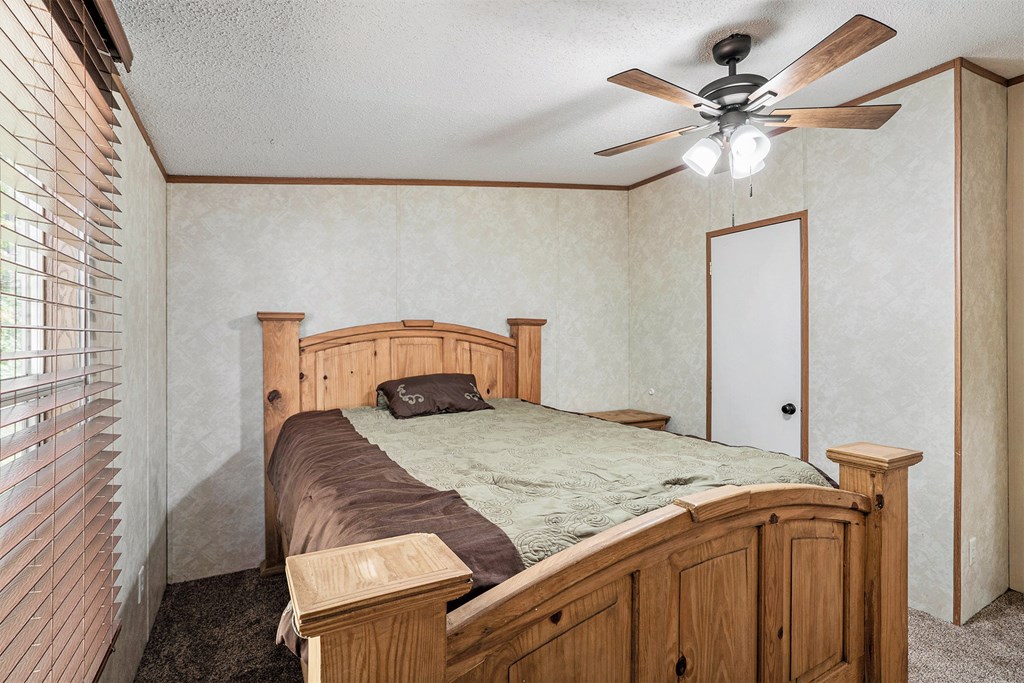 359 Norton Bridge Road Chatsworth, GA 30705 - Photo 21 of 28 a bedroom with a bed and a chandelier